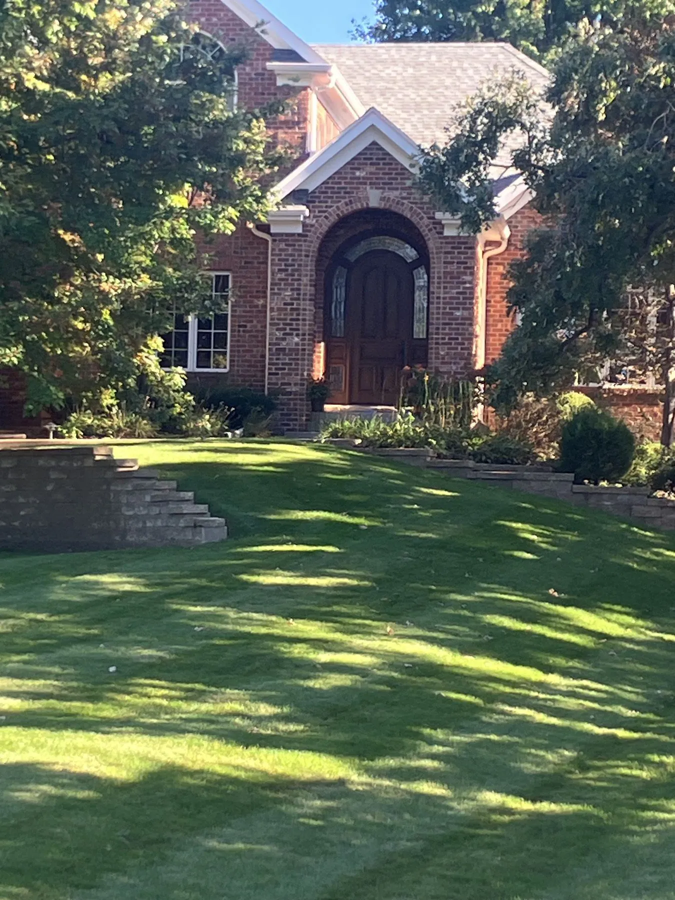 Brick home with a new arched front door and entry gable