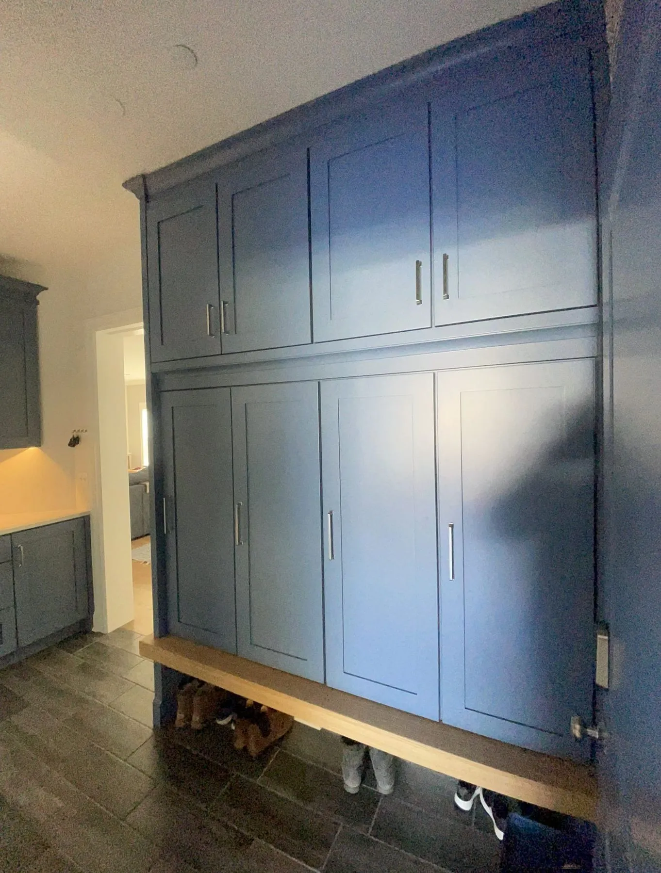 Blue built-in cabinets with a bench