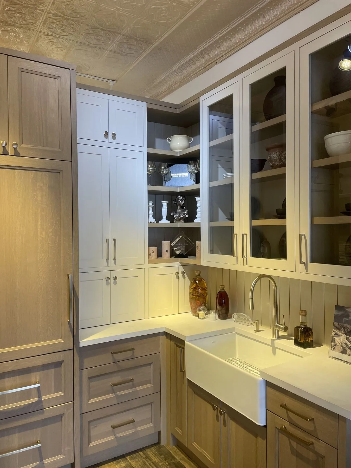 Glass cabinets and open shelves above a farmhouse sink