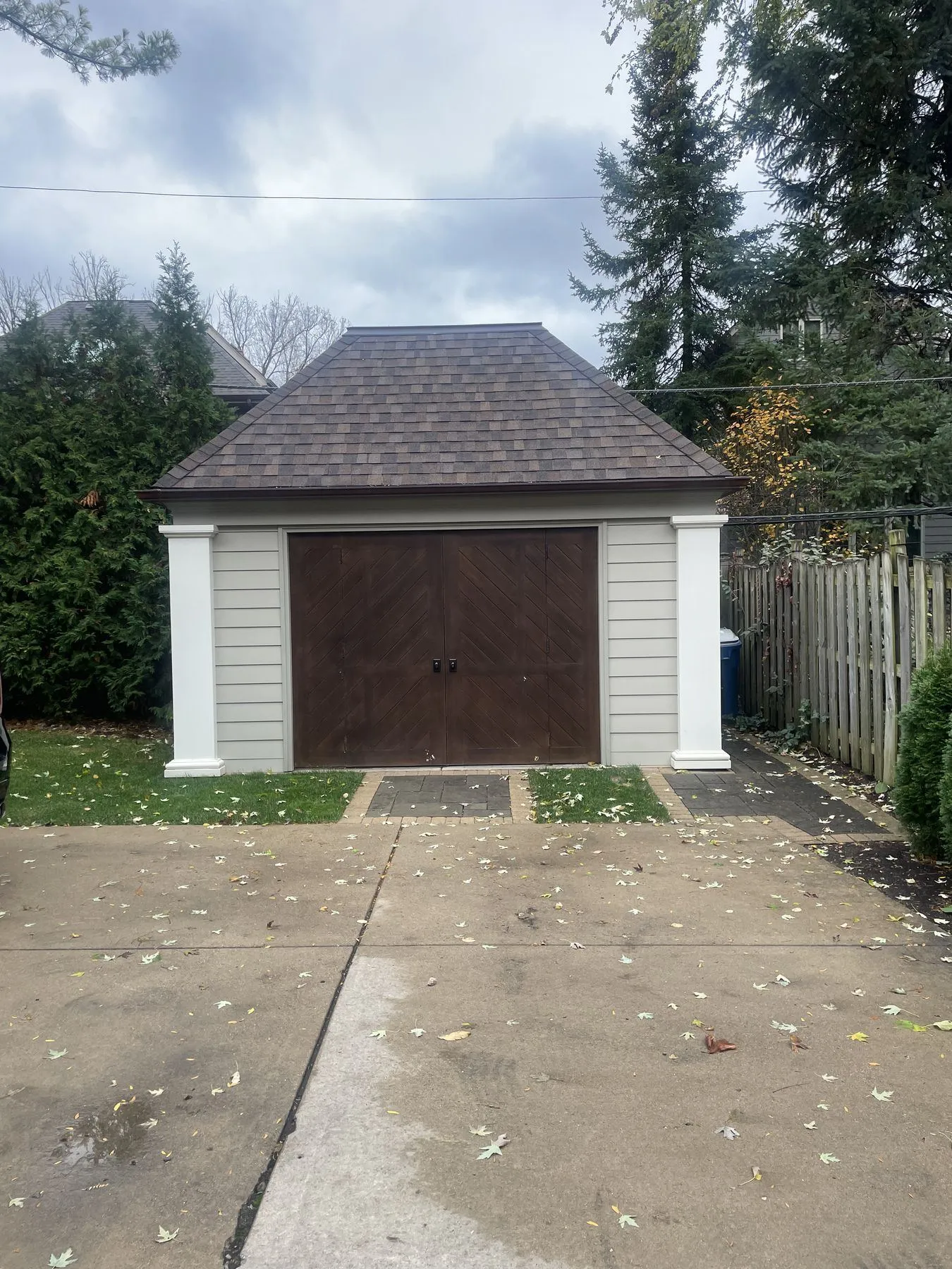 Storage shed with carriage-style wood doors