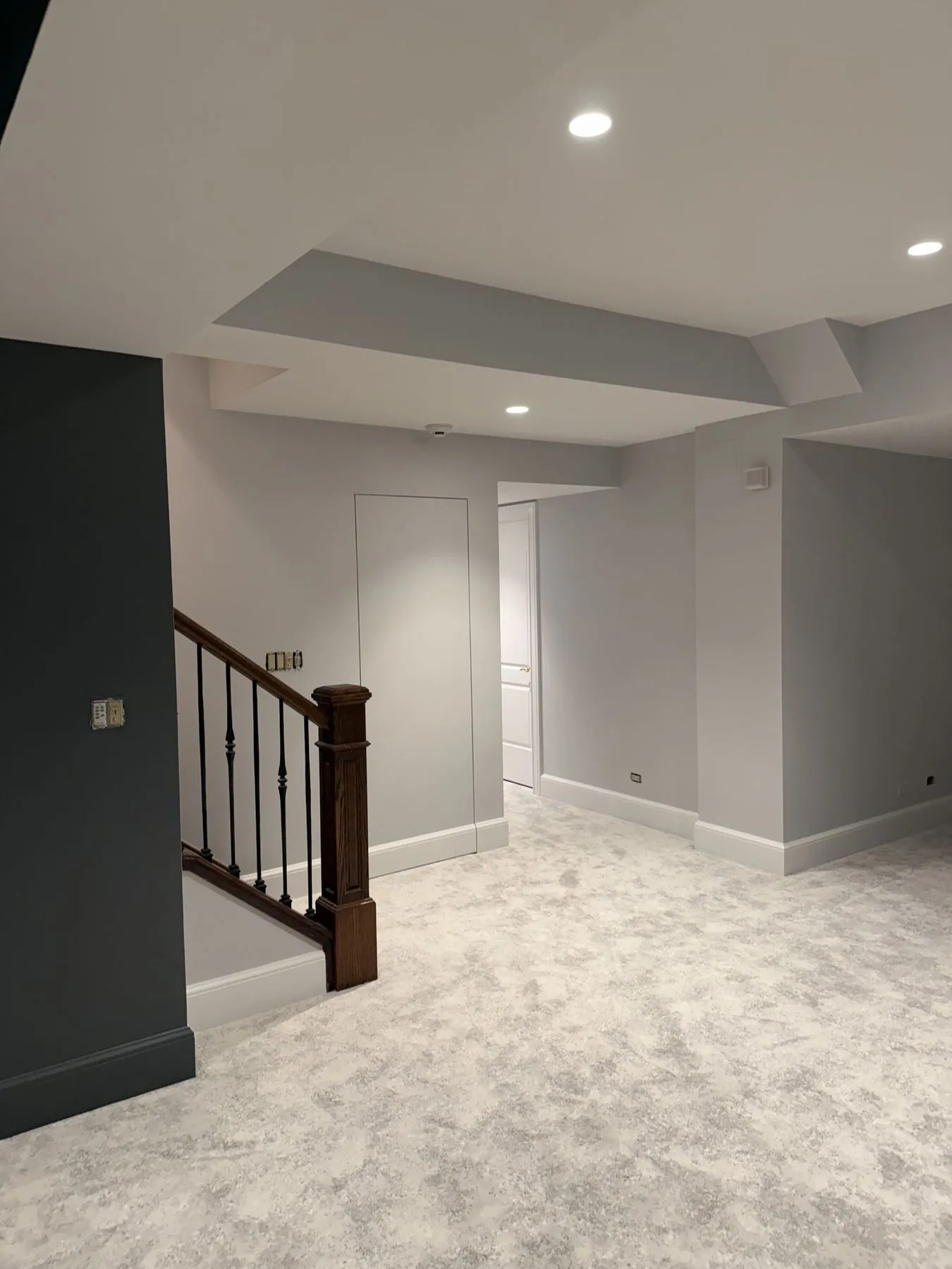 Basement stair with a wood rail