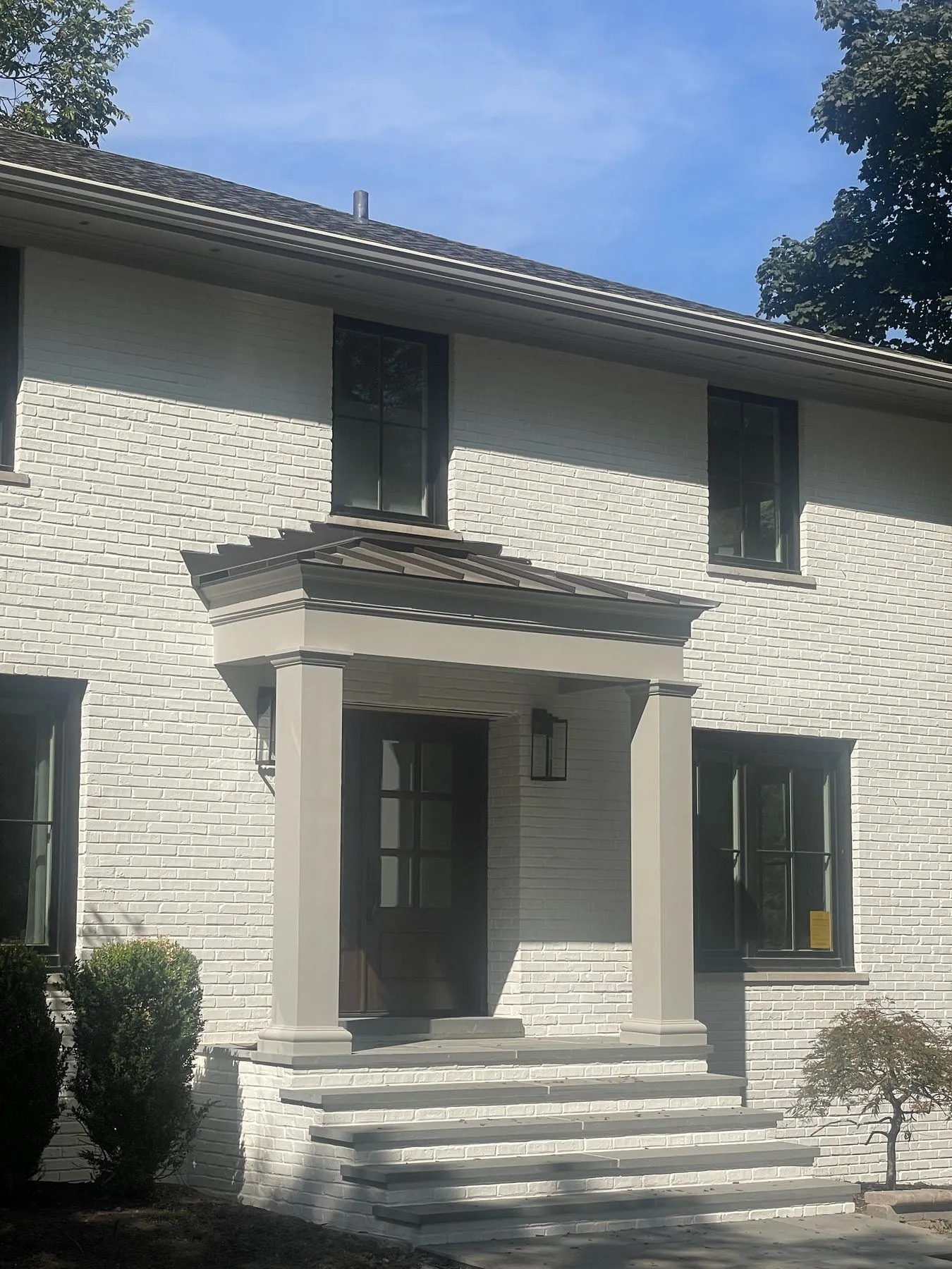 Portico and front steps on a painted brick home