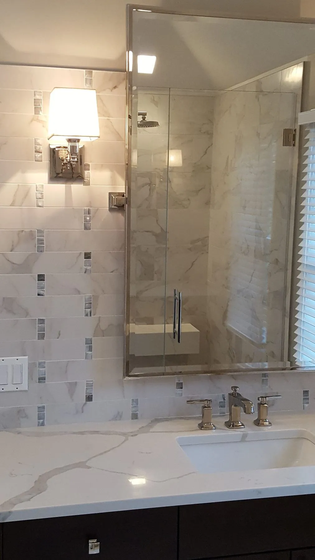 Mirror and faucet with a marble wall