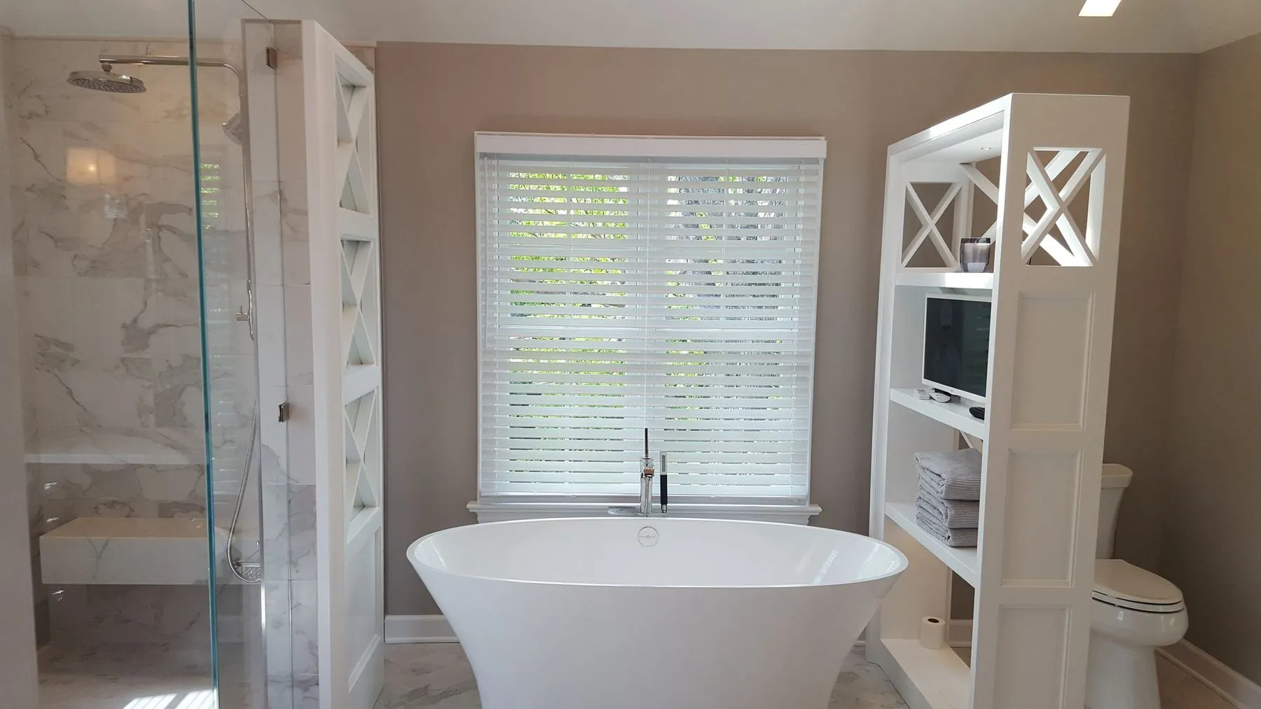 Tub between the shower and a storage tower