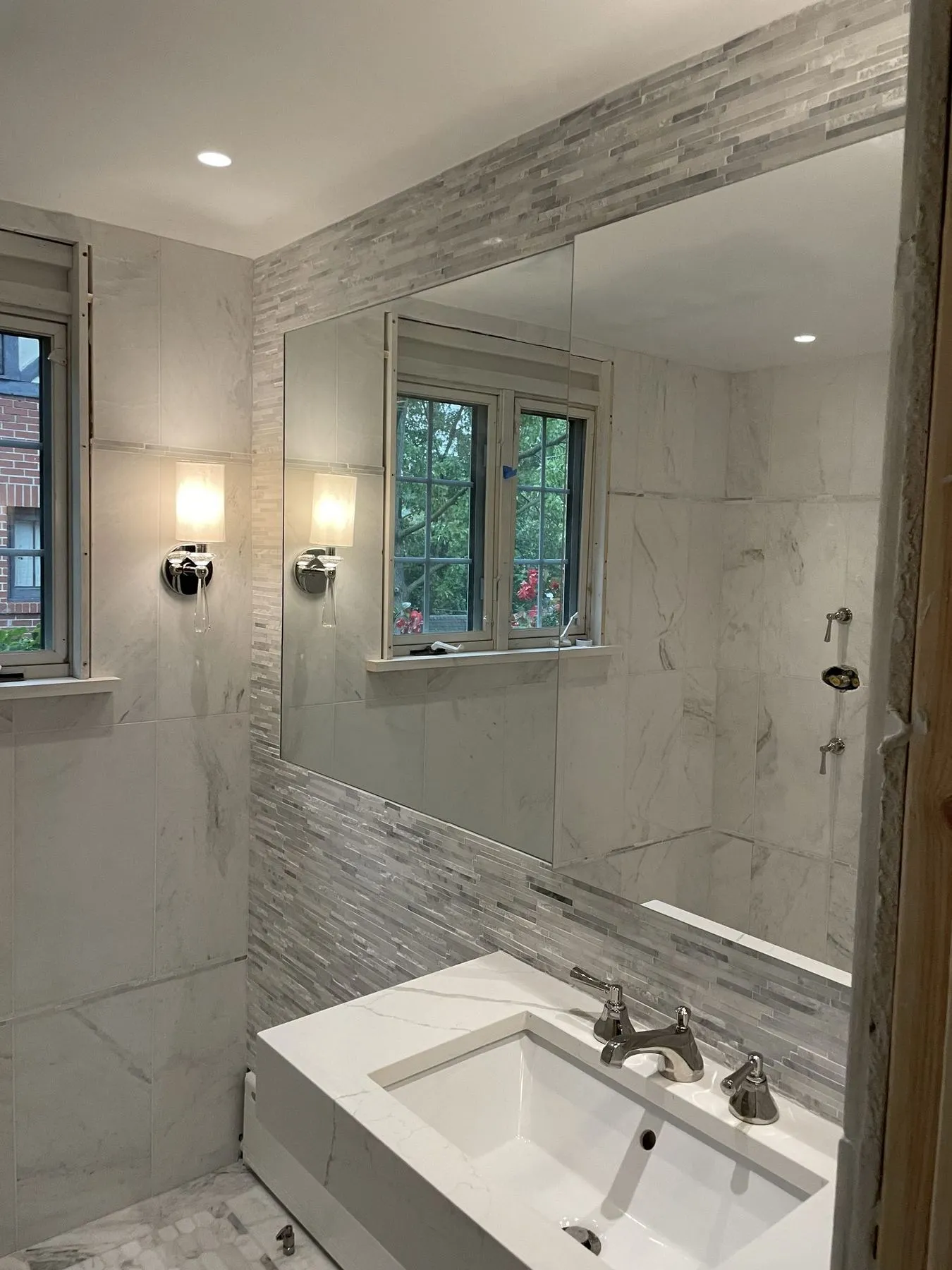 Marble wall and vanity with wall sconces