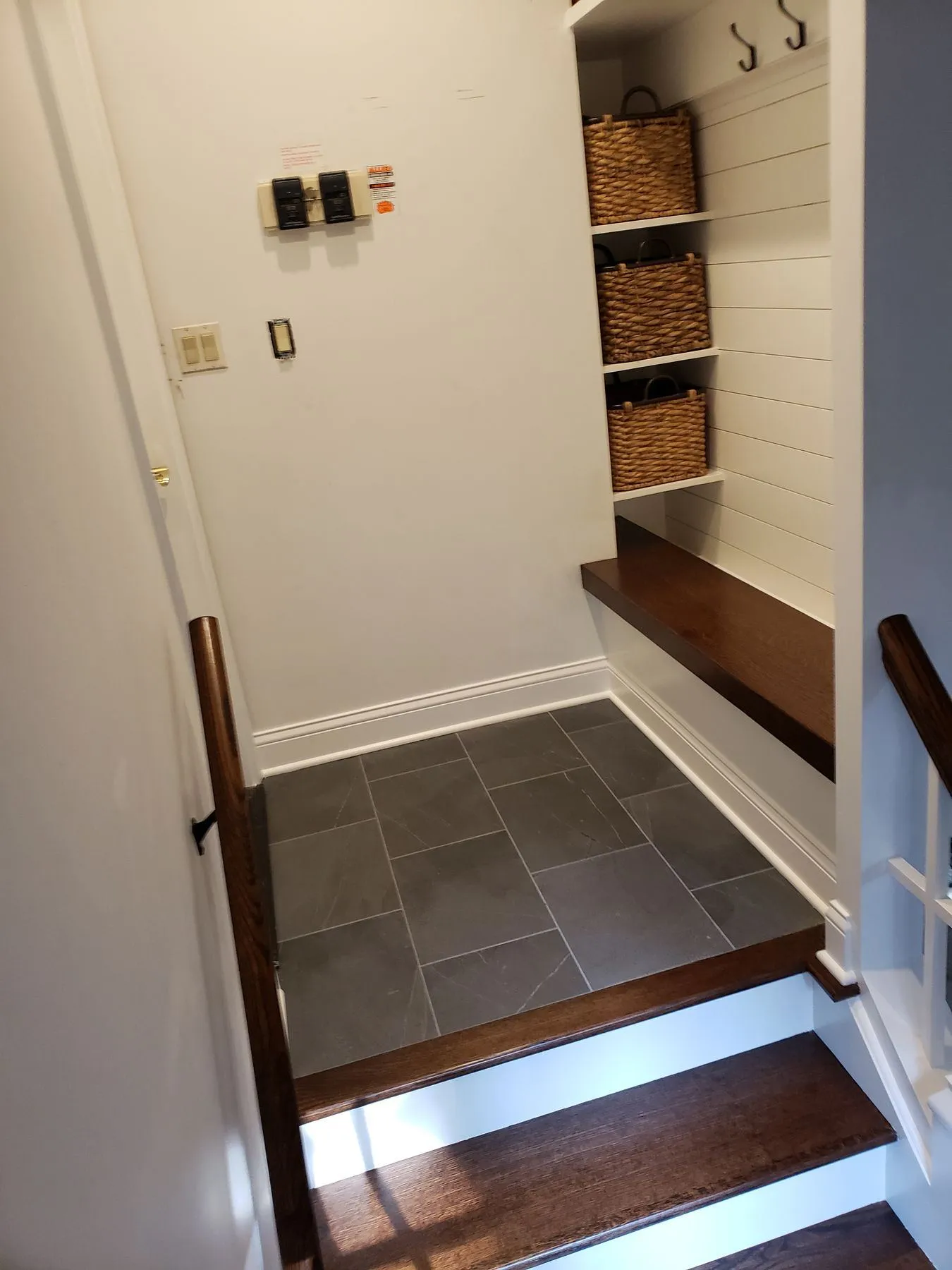 Mudroom landing with built-in cubbies and coat hooks