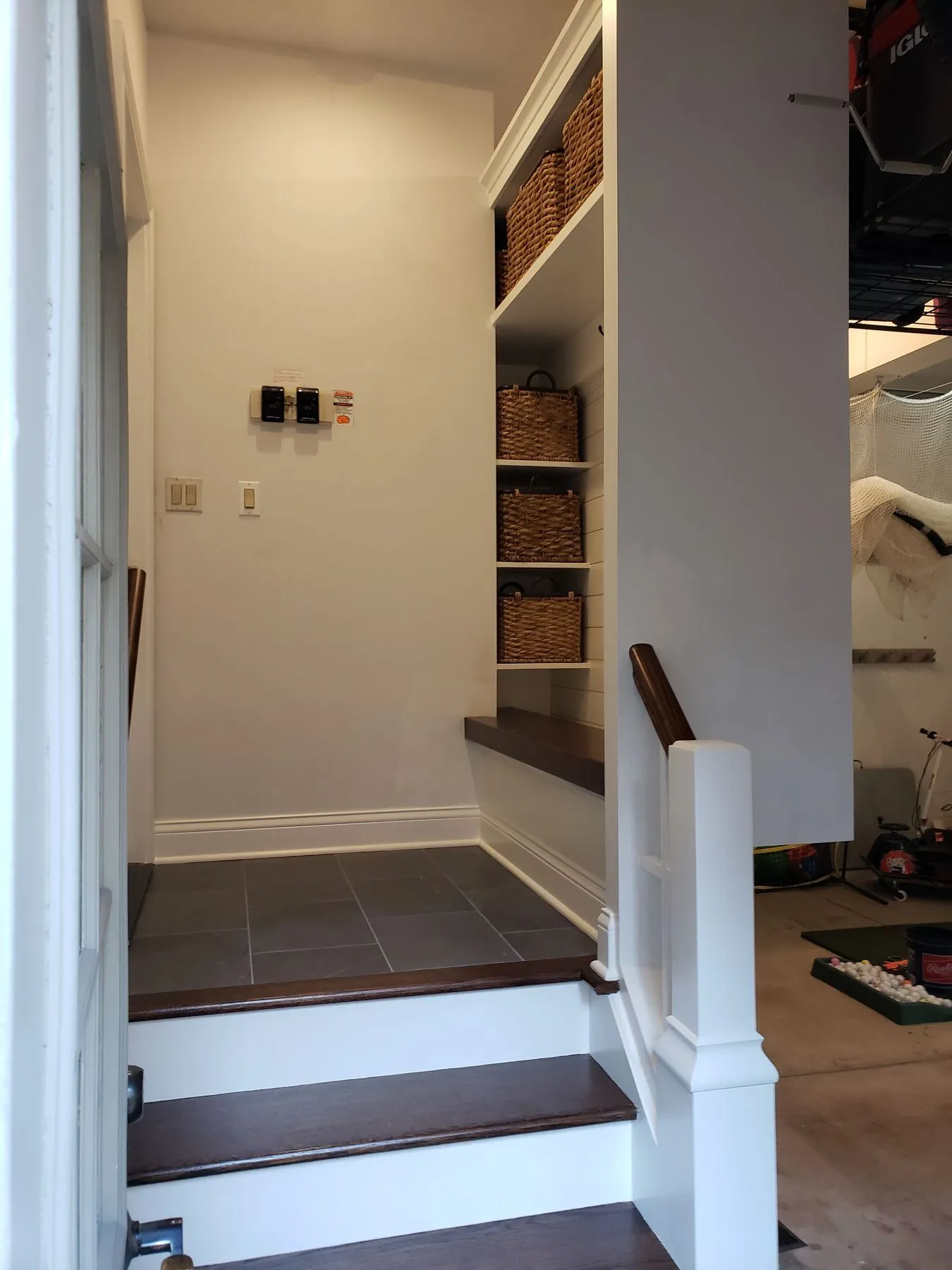 Mudroom seen from the garage door, with steps up to the house