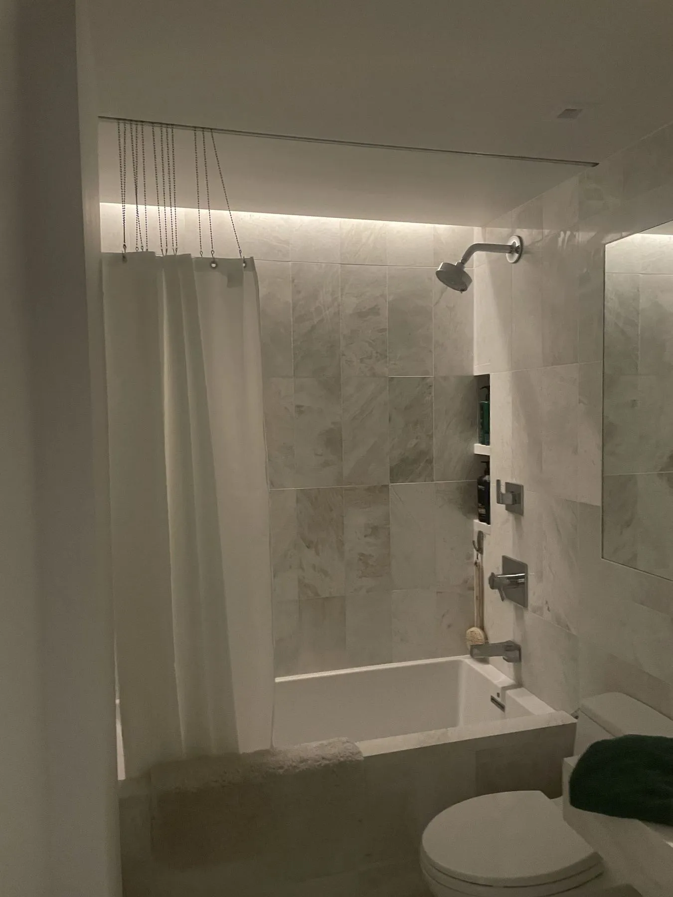Bathroom with marble tile and a tub