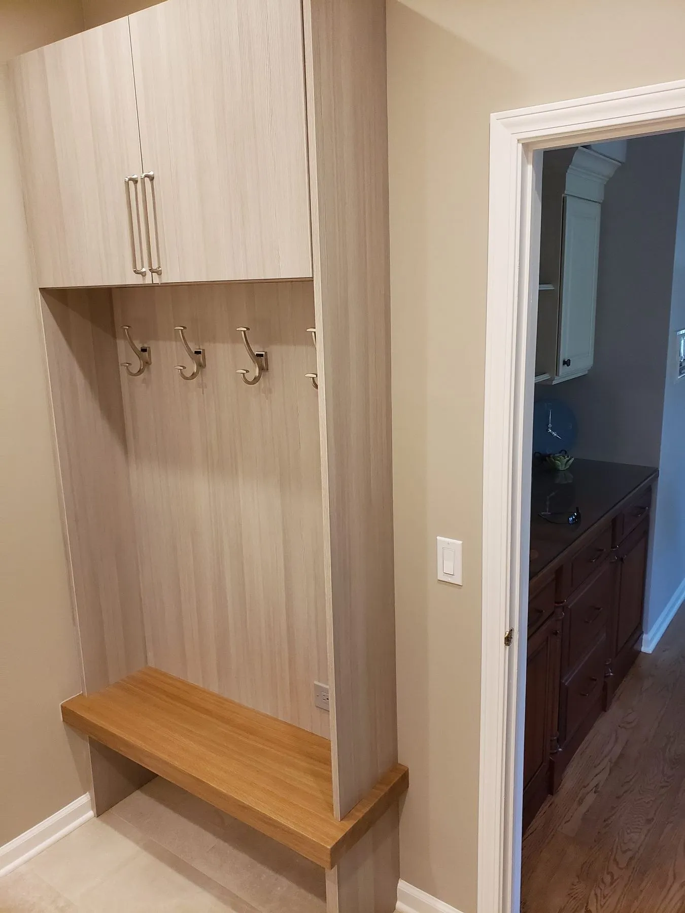 Mudroom locker with hooks and a wood bench