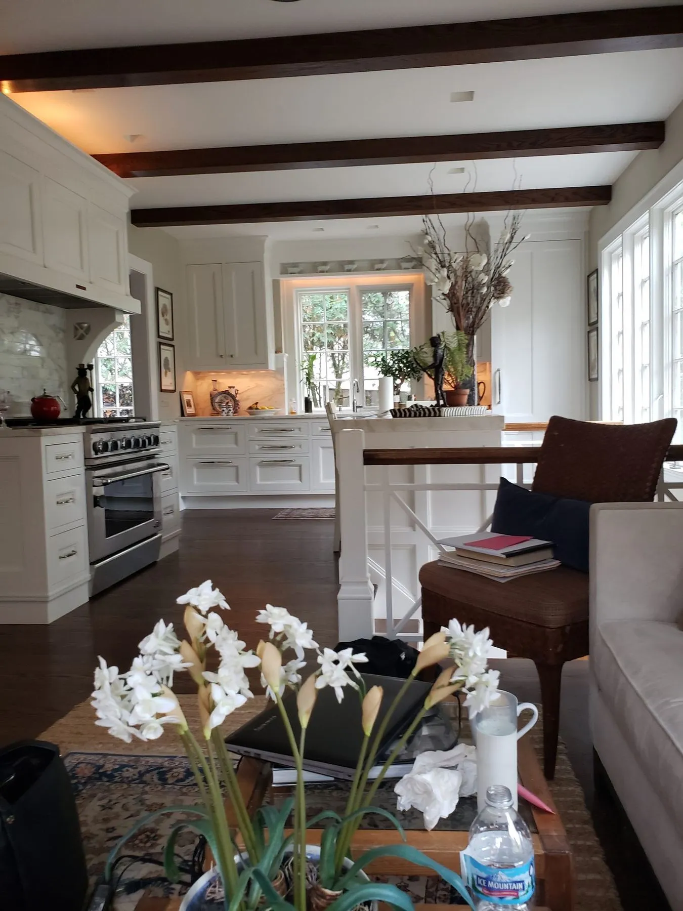 White kitchen with a professional range and beams overhead